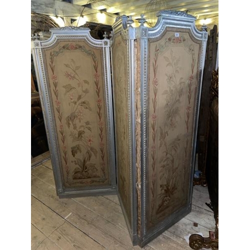 579 - A 19th century Louis XVI four panel screen with silvered paint finish and original needlework panels... 