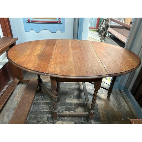 102 - A Victorian oak drop leaf oval dining table on barley twist legs, full measurements when extended 72... 