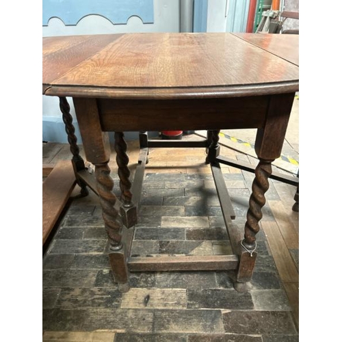 102 - A Victorian oak drop leaf oval dining table on barley twist legs, full measurements when extended 72... 