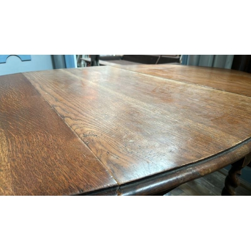 102 - A Victorian oak drop leaf oval dining table on barley twist legs, full measurements when extended 72... 