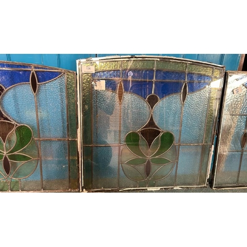 126 - A pair of matching stained glass windows, both slightly different sizes, largest 80cm (h) x 80cm (w)... 