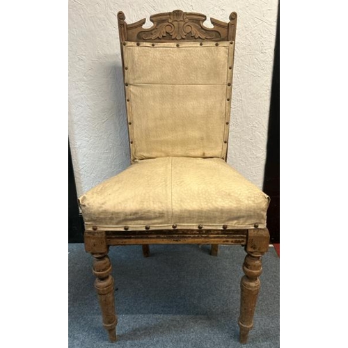 13 - An ornately carved oak dining chair with pinned upholstery, on two turned and fluted front legs, 95c... 