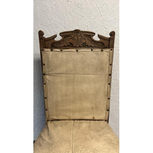 13 - An ornately carved oak dining chair with pinned upholstery, on two turned and fluted front legs, 95c... 