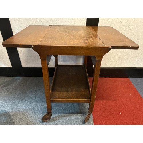 14 - A mid-century oak two-leaf folding tea caddy with platform underneath, on original casters, 70cm (h)... 