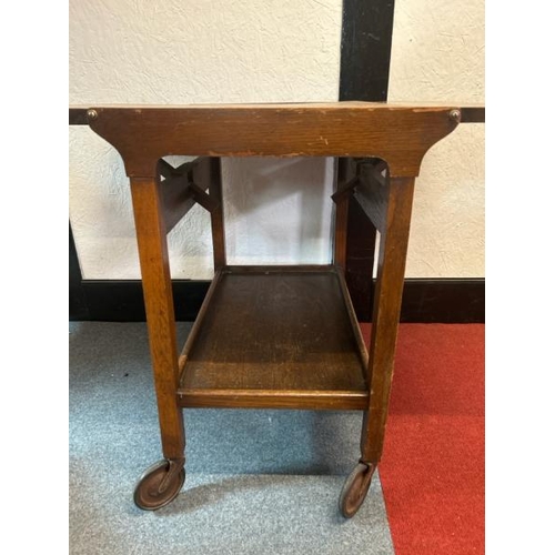 14 - A mid-century oak two-leaf folding tea caddy with platform underneath, on original casters, 70cm (h)... 