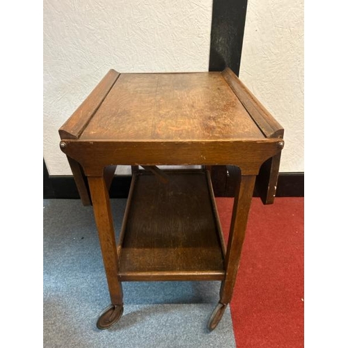 14 - A mid-century oak two-leaf folding tea caddy with platform underneath, on original casters, 70cm (h)... 