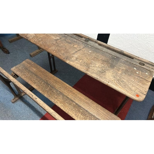 17 - A Victorian oak children's two seater school desk with folding lid on cast iron base, 58cm (h) x 98c... 