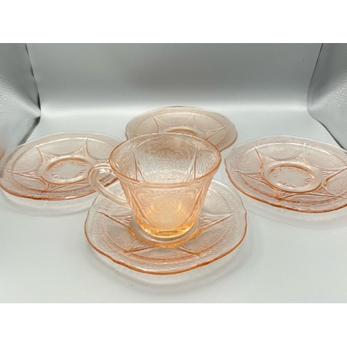 213 - Vintage pink glass cup and saucer with three additional saucers  / All lots are located at Gower Rec... 