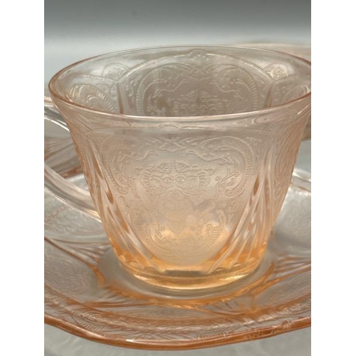 213 - Vintage pink glass cup and saucer with three additional saucers  / All lots are located at Gower Rec... 