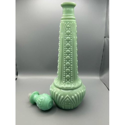 221 - Rare green milk glass genie bottle circa 1960 with non matching stopper, 29cm high  / All lots are l... 