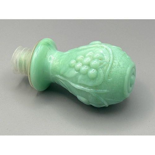 221 - Rare green milk glass genie bottle circa 1960 with non matching stopper, 29cm high  / All lots are l... 