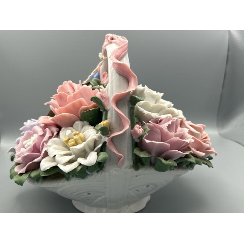 234 - Vintage porceline flower basket with some minor damage to top of handle, 19cm high  / All lots are l... 