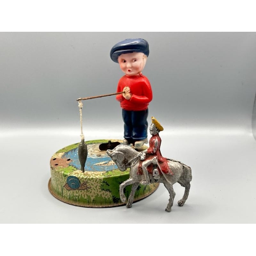 250 - Mettoy tin plate Billy the fisherman, incomplete but clockwork working, with a small lead military h... 