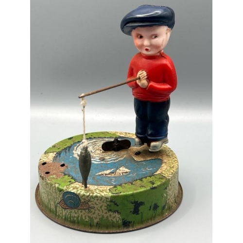 250 - Mettoy tin plate Billy the fisherman, incomplete but clockwork working, with a small lead military h... 