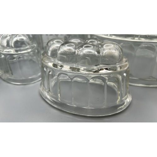 257 - Five glass jelly moulds of various sizes, largest 12cm (h)  / All lots are located at Gower Reclamat... 