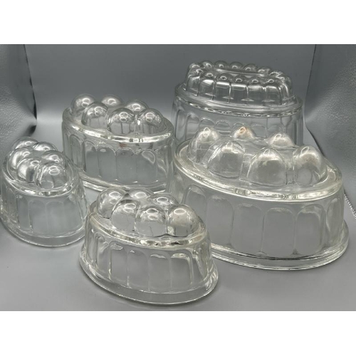 257 - Five glass jelly moulds of various sizes, largest 12cm (h)  / All lots are located at Gower Reclamat... 