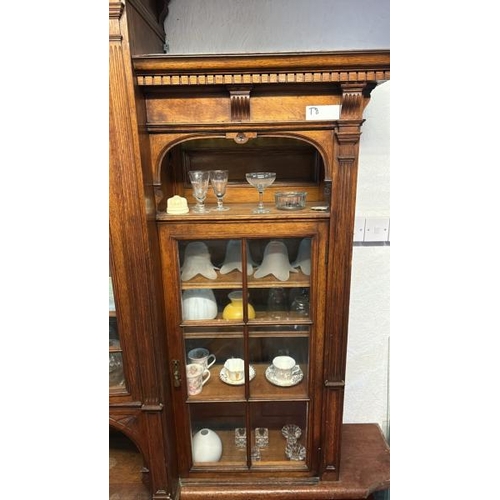 26 - An Edwardian oak top section of a dresser with ornately carved paneling and glazed features, on unas... 