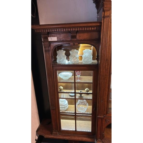 26 - An Edwardian oak top section of a dresser with ornately carved paneling and glazed features, on unas... 