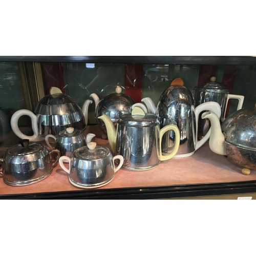 260 - A collection of Art Deco silver plate insulated tea pots, coffee pots, and sugar bowls, 9 pieces,   ... 