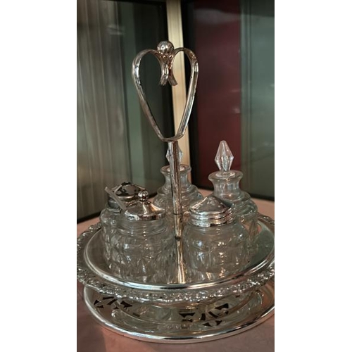 264 - A collection of cut glass and plated condiment pots and bottles  / All lots are located at Gower Rec... 