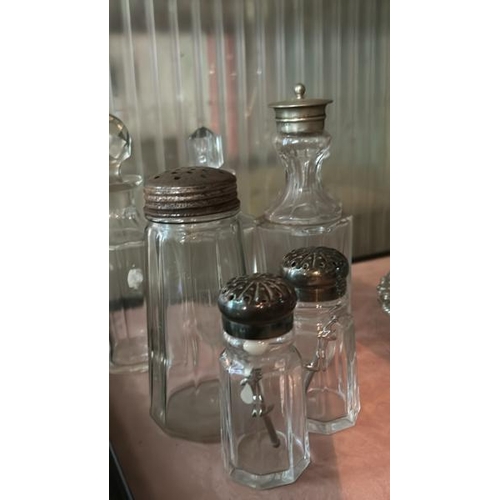 264 - A collection of cut glass and plated condiment pots and bottles  / All lots are located at Gower Rec... 