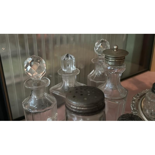 264 - A collection of cut glass and plated condiment pots and bottles  / All lots are located at Gower Rec... 