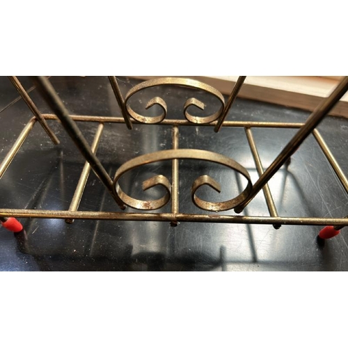 42 - A vintage brass magazine rack, one slightly damaged leg, 33cm (h) x 32cm (w)  / All lots are located... 