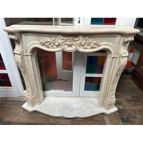 53 - A white marble resin copy fireplace surround, on authentic white marble base, profusely decorated wi... 