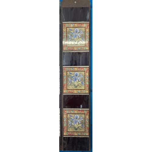 567 - Half set of three blue iris fireplace tiles, each 14cm squared, with metal tile holder  / All lots a... 