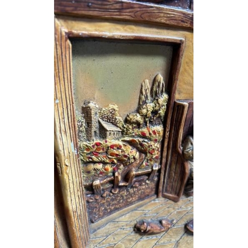 57 - A decorative ceramic wall plaque depicting a pub scene, 38cm (dia)  / All lots are located at Gower ... 