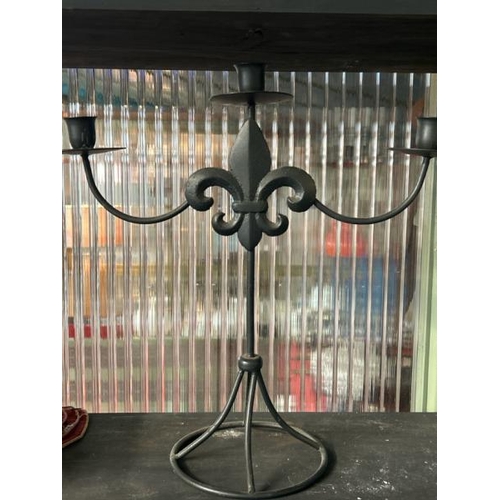 604 - Three armed metal candelabra with fleur de lis decoration, 39cm (h) x 38cm (w)  / All lots are locat... 