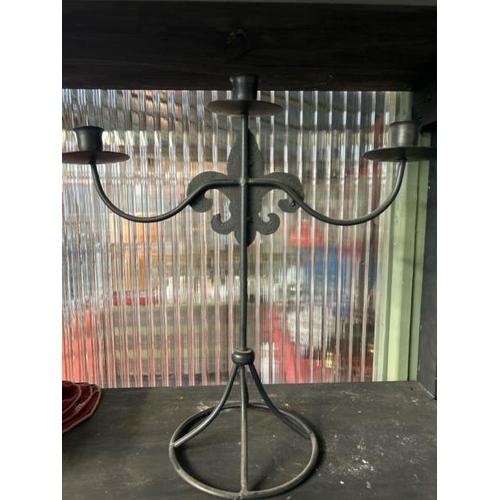 604 - Three armed metal candelabra with fleur de lis decoration, 39cm (h) x 38cm (w)  / All lots are locat... 