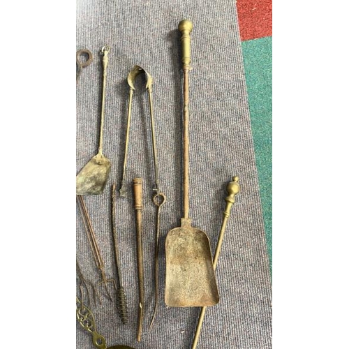 619 - Collection of vintage brass and metal fire tools including shovels, tongs and chestnut warmer  / All... 