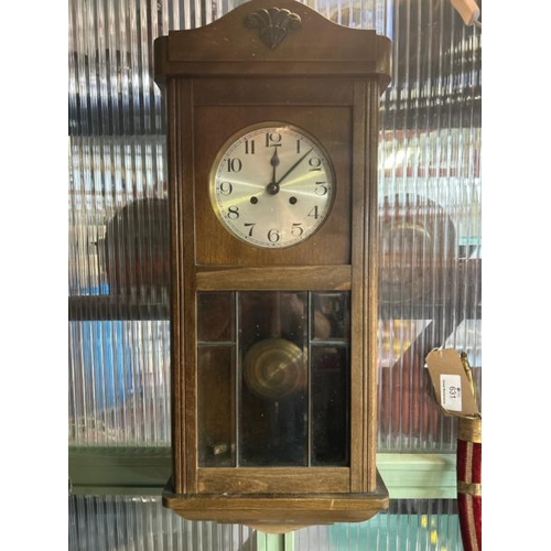 661 - Oak cased clock with brass face, pendulum and key, clock face is 17cm diameter, 75x33x18cm  / All lo... 