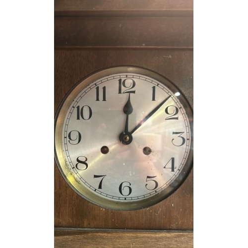 661 - Oak cased clock with brass face, pendulum and key, clock face is 17cm diameter, 75x33x18cm  / All lo... 