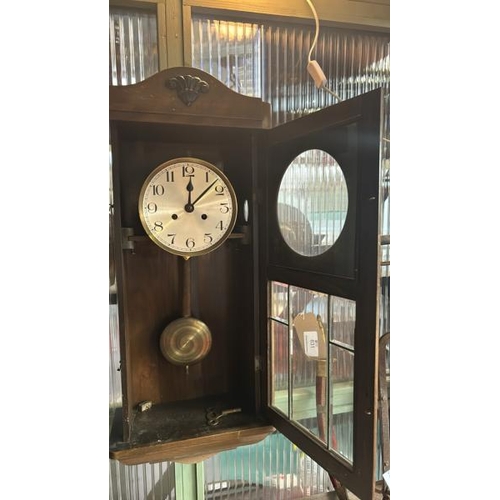 661 - Oak cased clock with brass face, pendulum and key, clock face is 17cm diameter, 75x33x18cm  / All lo... 