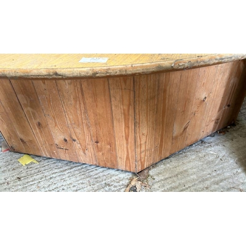 752 - A large circular wooden display plinth on octagonal base, 49cm (h) x 178cm (dia)  / All lots are loc... 