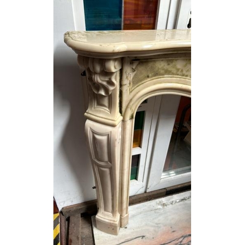 758 - A white marble resin copy fireplace surround, on authentic white marble base, profusely decorated wi... 