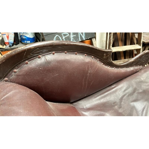 764 - Victorian chaise longue, with leather upholstery and carved wooden detail throughout, on turned and ... 