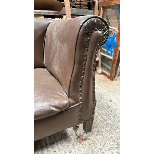 781 - A two seater faux leather sofa, 70cm (h) x 142cm (w) x 70cm (d)  / All lots are located at Gower Rec... 