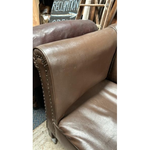 781 - A two seater faux leather sofa, 70cm (h) x 142cm (w) x 70cm (d)  / All lots are located at Gower Rec... 