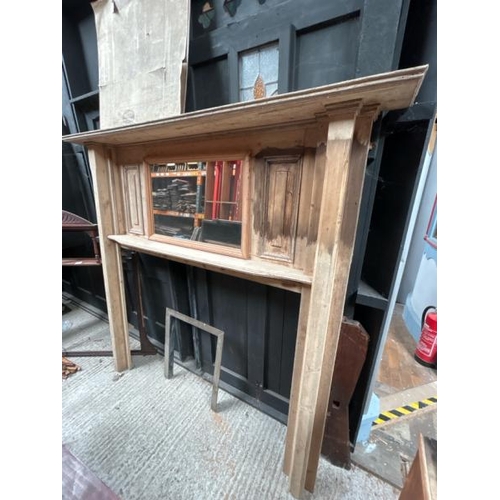 784 - A large stripped pine fireplace surround with mantle and central framed mirror, 181.5cm (h) x 193.5c... 