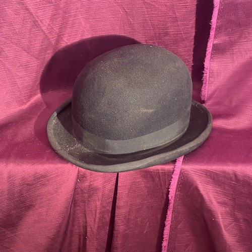 729 - Early 20th century vintage black bowler hat with ribbon trim and satin lining.    / All lots are loc... 