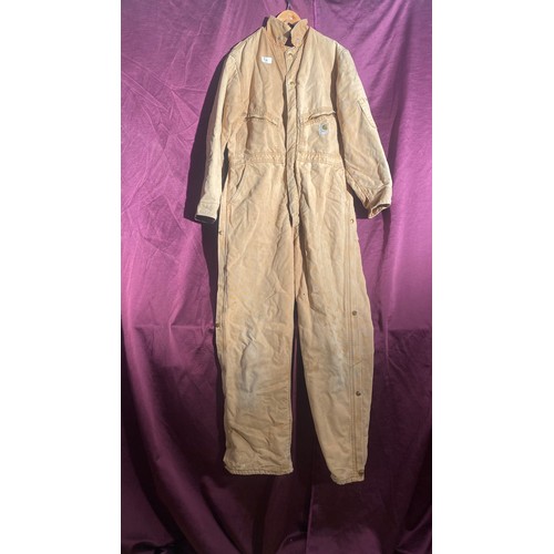 730 - Carhartt beige coverall features multiple pockets and snap closures.   / All lots are located at The... 