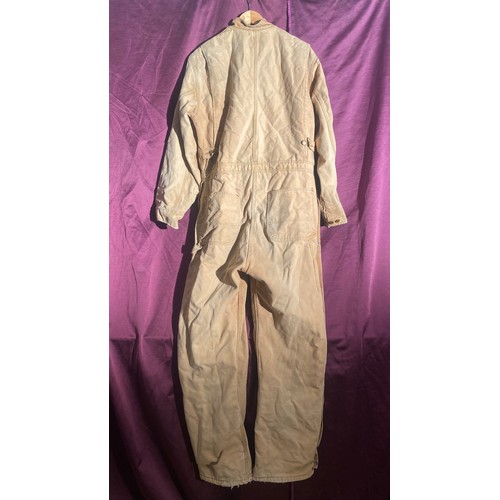 730 - Carhartt beige coverall features multiple pockets and snap closures.   / All lots are located at The... 