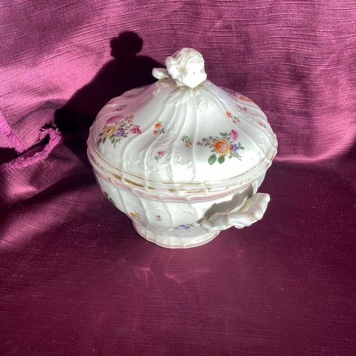 746 - This is an ornate porcelain tureen with a lid and a floral motif. It features intricate handles and ... 