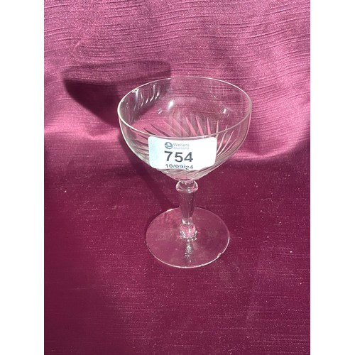 754 - Vintage etched glass champagne coupe featuring an elegant swirl pattern.   / All lots are located at... 