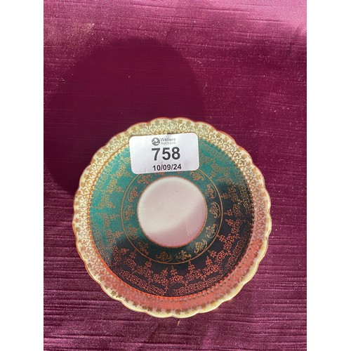 758 - An ornate porcelain saucer with intricate green and gold pattern detailing. It has scalloped edges. ... 