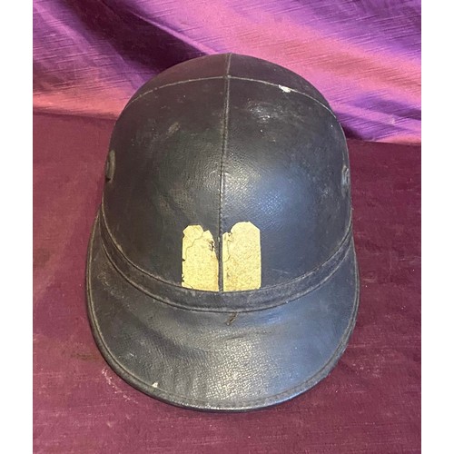 855 - Vintage black leather helmet with a strap, showcasing dual vertical yellow and red lines on the fron... 