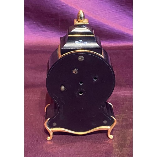 867 - Mid 20th century black enamel mantel clock with floral accents, Roman numeral dial, and gold trim de... 